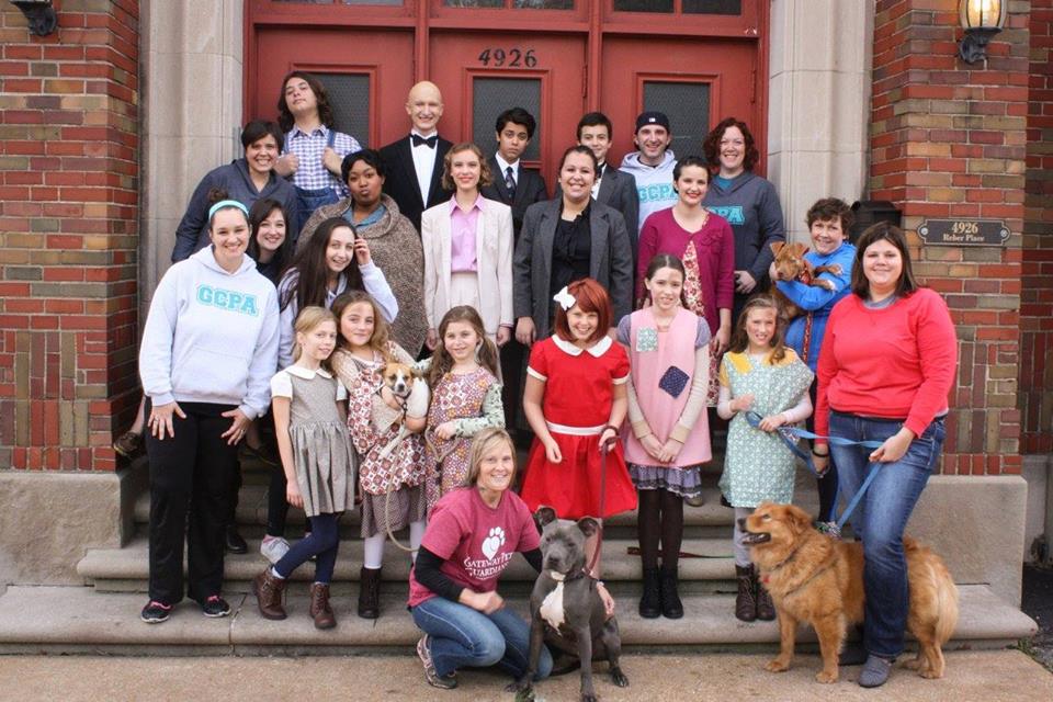 The cast of "Annie Warbucks" poses with adoptable dogs and volunteers from Gateway Pet Guardians