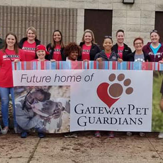 Group with sign: Future home of Gateway Pet Guardians